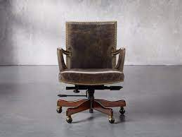 Think a classic black leather desk chair behind a wood desk. Martello Leather Desk Chair Arhaus