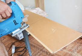 You need the sliding action of a sliding miter saw to cut the full width of the plank. Cutting Laminate Flooring Lengthwise Cutting Laminate Flooring With Hand Saw Stock Photo Picture And Royalty Free Image Image 87735485