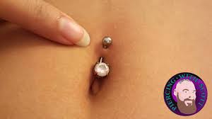 How to stop a belly piercing from rejecting