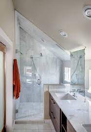 In a bathroom with a sloping ceiling, the walls are often inclined. House Covered In Wood Delivers Privacy In Style Sloped Ceiling Bathroom Small Attic Bathroom Loft Bathroom