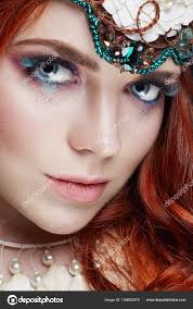 redhead with bright makeup and big