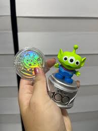 toy story alien figurine and medallion