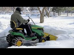 snow plowing with lawn tractor blade