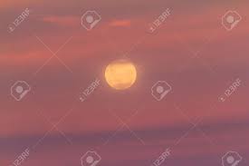 A Yellow Full Moon Rising Into Pink Sunset Clouds Stock Photo, Picture And  Royalty Free Image. Image 89616153.