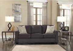 dark tan walls with a dark gray couch
