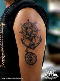 Broken compass tattoo with ribbon for men. Anchor Tattoo Compass Tattoo Wheel Tattoo We Must Learn To Sale In High Winds Compass Tattoo Design Is Suited Tattoos Compass Tattoo Compass Tattoo Design