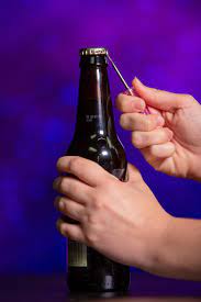 Hold the bottle in one hand and with the other, place the lighter under the cap and push down hard. 15 Clever Ways To Open A Beer Without A Bottle Opener Cnet