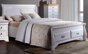 white wood sleigh bed with end drawers