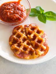 This low carb crispy pizza crust is made in a mini waffle maker with almond flour, an egg, cheese and seasoning. Pizza Chaffle The Girl Who Ate Everything