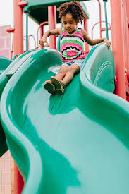 Illustration of water slide with background. A Little Girl Sliding Down A Green Slide At The Playground By Kristen Curette Daemaine Hines