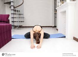 does yoga exercises on mat on the floor