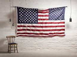American Flag Hanging On White Brick Wall