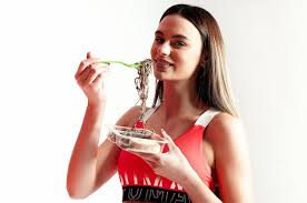 premium photo a woman eating noodles