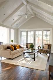 Vaulted or cathedral ceilings in a living room can create a dramatic and spacious look. 60 Comfy Farmhouse Sunroom Makeover Decor Ideas High Ceiling Living Room Cathedral Ceiling Living Room Vaulted Ceiling Living Room