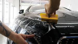 Decorate your car with paint protection film from alibaba.com. Close Up To Ppf Installation Process On A Front Headlight And Hood Ppf Is A Paint