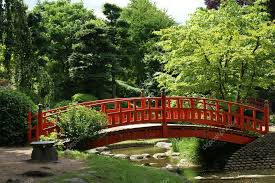 Red Bridge In A Japanese Garden Stock