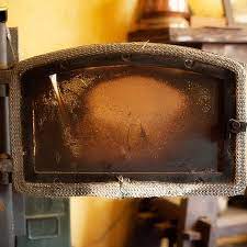 Clean The Glass Door Of A Wood Stove