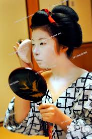 a maiko appice geisha with her