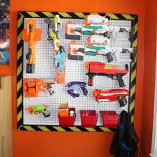 Space out 2 pegs at approximately the same length as the nerf gun and hang the gun hang a wire rack on your wall using screws, anchors, or other attachments depending on the wall material. Nerf Wall Diy A How To Guide For Creating Your Nerf Gun Wall