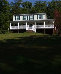 The new porch extends the length of the front of the house, makes a neat mitered corner, and then runs along the side of the house, where a rickety side porch once stood. Wrap Around Porch Addition In Hedgesville Fine Line Home Design Llc