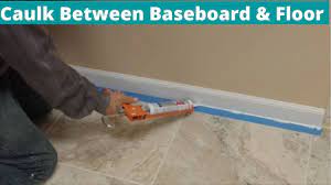 how to caulk between baseboard and tile