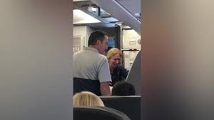 American Airlines flight attendant hits mum with her baby buggy.