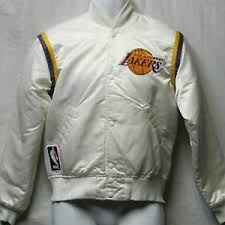 This jacket is a satin black with silver and white trim detail on the collar, wrists and waist, two front side slit pockets and a white liner. Starter Jackets Coats Vintage 8s La Lakers Starter Warm Up Jacket Poshmark