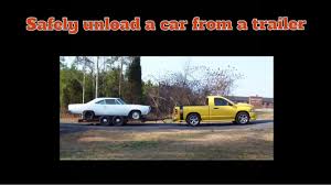 properly unload a car from a trailer