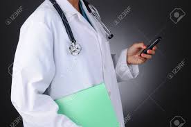 Closeup Of A Nurse Holding A Chart In One Hand Abd Her Cell Phone