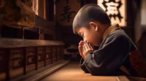 young boy praying in a buddhist room