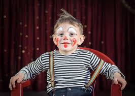 smiling cute male kid with mime makeup