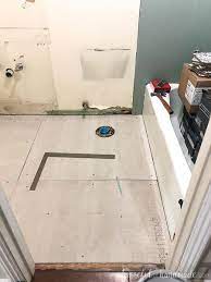 laying floor tiles in a small bathroom