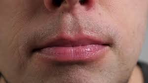 man lick his lips closeup stock