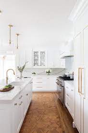 white kitchen with parquet wood floors