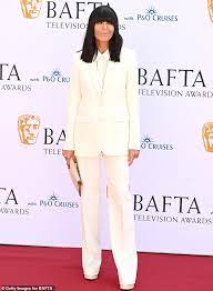 Claudia Winkleman shows off her trademark fringe as she attends the BAFTA Television Awards 2024 in a cream trouser-suit | Daily Mail Online