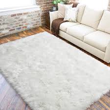 A good rule of thumb to follow is that a rug should extend 12 to 18 inches beyond the furniture it's underneath. Amazon Com Lochas Ultra Soft Fluffy Rugs Faux Fur Sheepskin Area Rug For Bedroom Bedside Living Room Carpet Washable Floor Carpets 5x8 Feet White Kitchen Dining