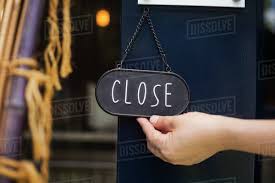 Close Up Of Person Turning Closed Sign On Glass Door D1024_95_091