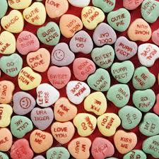 This design features a photo of sweetheart conversation heart candies. Large Group Of Colorful Candy Hearts With Sayings On Them Arranged On Red Background Stock Photo Picture And Royalty Free Image Image 2190098
