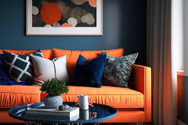 orange throw pillows and a navy blue