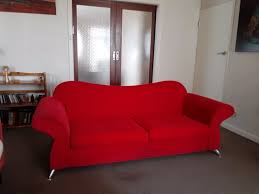 red velvet couch with metal in