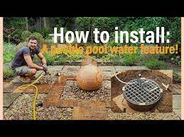 Install A Pebble Pool Water Feature