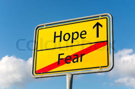 Yellow street sign with Hope ahead leaving Fear behind | Stock image |  Colourbox