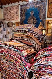 large stacks of oriental rugs