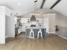 There are hardwood floors in kitchen/dining room, black appliances, pantry, and a peninsula that can be used for extra seating. Elevate Design Build