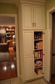 Tall units like this is perfect for storing ironing boards and standing/stick vacuum cleaners. F White Wooden Tall Narrow Pantry Cabinet With Maple Wood Shelves And Wooden Door Panel T Stand Alone Kitchen Pantry Corner Pantry Cabinet Freestanding Kitchen