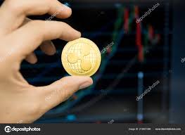 Male Businessman Hand Holding Ripple Coin On A Background Of