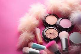 black makeup set with a pink background