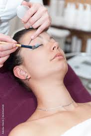 apply makeup to woman s eyelids stock