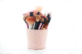 make up brushes in a pot isolated on white