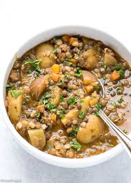 lentil potato soup recipe lentil soup in a white ceramic bowl with a spoon inside